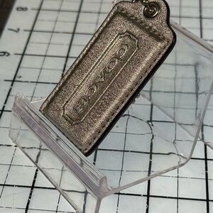 COACH Silver Metallic hang tag  Accessory. 3 inch by 1.5